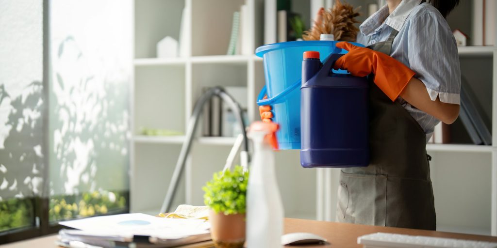 Young woman cleaning to disinfect the office office cleaning staff cleaning maid. Female cleaner